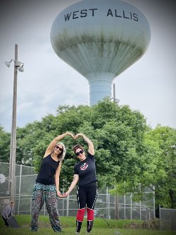 two women standing in front of water tower